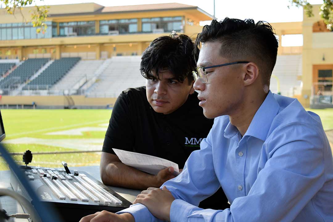 Truong and Martinez make sure graphics and packages are in order for the start of the show, which is less than an hour away. Alex G. Spanos Stadium, San Luis Obispo, CA. Oct. 26.