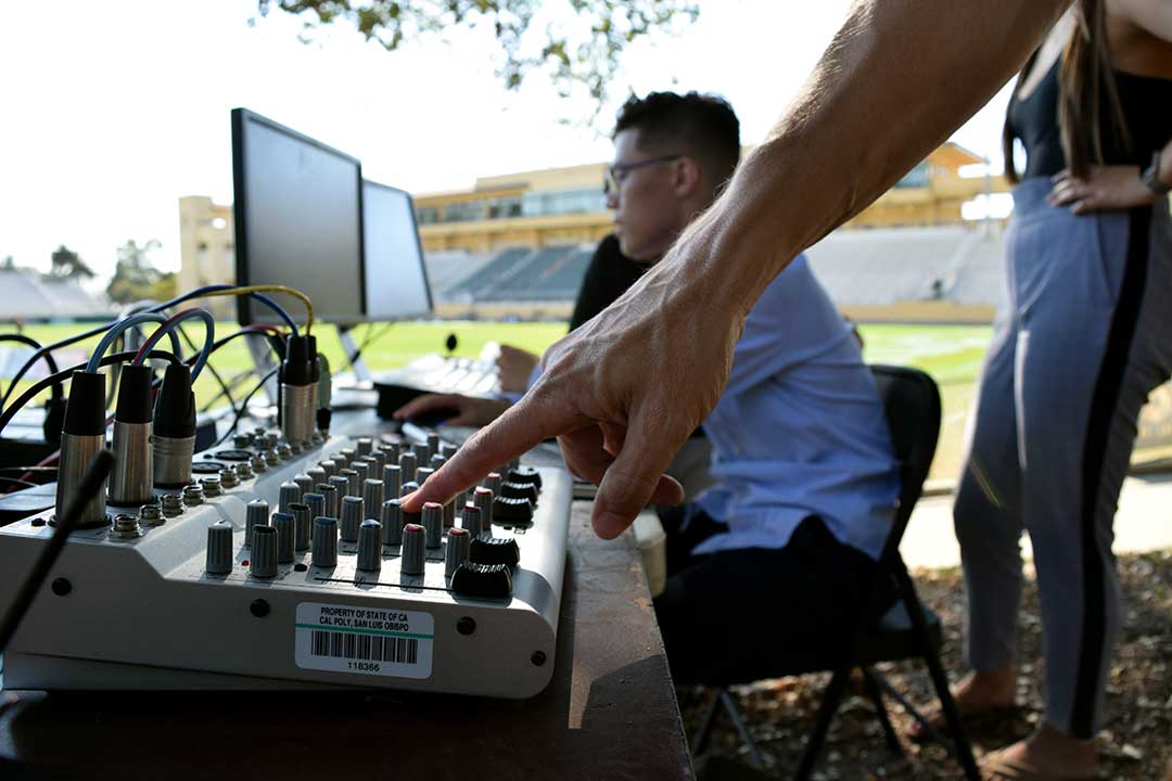 Morales checks audio levels after all the broadcast equipment is set up. Alex G. Spanos Stadium, San Luis Obispo, CA. Oct. 26.