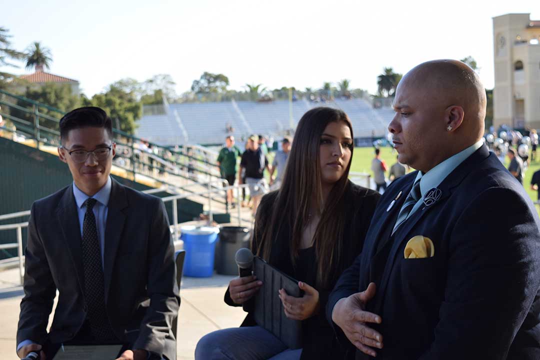 Truong, journalism senior Sydney Finkel and Mustang Gameday's first guest, Cal Poly play-by-play announcer Veejay Huskey, prepare for an on-air interview. Alex G. Spanos Stadium, San Luis Obispo, CA. Oct. 26.